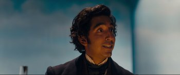 Movie still from “The Personal History of David Copperfield” (2019), directed by Armando Iannucci – A person wearing a suit and tie; Close Up shot, Low angle