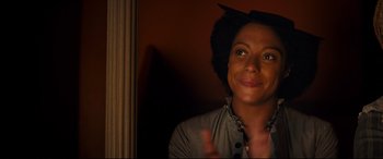 Movie still from “The Personal History of David Copperfield” (2019), directed by Armando Iannucci – A woman smiling and giving the peace sign; Close Up shot, Over the shoulder angle