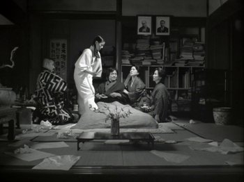 A group of people sitting on the ground in a room