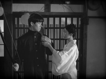 Movie still from “The Pillow Book” (1995), directed by Peter Greenaway – A man and a woman in traditional japanese garb; Medium shot, Low angle
