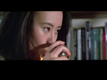 Movie still from “The Pillow Book” (1995), directed by Peter Greenaway – A person holding a cell phone; Close Up shot, High angle