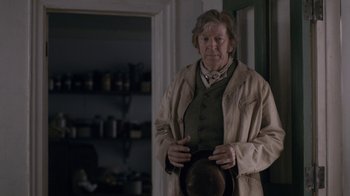 Movie still from “Anne with an E” (2017), created by Moira Walley-Beckett – An older man holding a hat in a room; Medium shot, Over the shoulder angle
