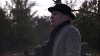Movie still from “Anne with an E” (2017), created by Moira Walley-Beckett – An older man wearing a black hat and a black scarf; Close Up shot, Low angle