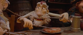 Movie still from “The Pirates! Band of Misfits” (2012), directed by Jeff Newitt – A sculpture of a man cutting a piece of pizza; Close Up shot, High angle