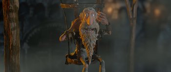 Movie still from “The Pirates! Band of Misfits” (2012), directed by Jeff Newitt – A clay sculpture of an old man swinging on a swing; Medium shot, Low angle