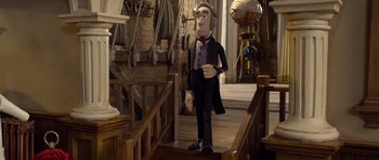 Movie still from “The Pirates! Band of Misfits” (2012), directed by Jeff Newitt – A statue of a man in a suit standing on a staircase; Wide shot, Low angle