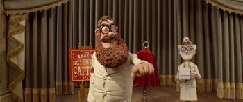 Movie still from “The Pirates! Band of Misfits” (2012), directed by Jeff Newitt – A statue of a man with a long beard and glasses; Medium shot, Low angle