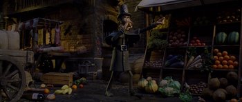 Movie still from “The Pirates! Band of Misfits” (2012), directed by Jeff Newitt – A statue of a man in a costume in front of a market; Wide shot, Low angle