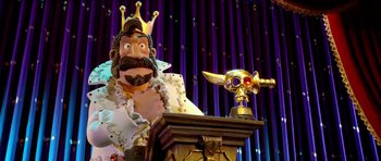 Movie still from “The Pirates! Band of Misfits” (2012), directed by Jeff Newitt – A statue of a king with a gold mask on his head; Medium shot, Low angle