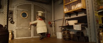 Movie still from “The Pirates! Band of Misfits” (2012), directed by Jeff Newitt – A toy of a chef in a kitchen setting; Wide shot, High angle