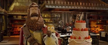 Movie still from “The Pirates! Band of Misfits” (2012), directed by Jeff Newitt – A cake that looks like an owl and a bearded man; Medium shot, Over the shoulder angle