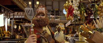 Movie still from “The Pirates! Band of Misfits” (2012), directed by Jeff Newitt – A statue of a man holding a spatula next to a bird; Medium shot, Over the shoulder angle