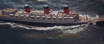 Movie still from “The Poseidon Adventure” (1972), directed by Ronald Neame – An aerial view of a cruise ship in the ocean; Extreme Wide shot, Overhead angle