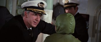 Movie still from “The Poseidon Adventure” (1972), directed by Ronald Neame – A man in a uniform talking to another man in a green jacket; Close Up shot, Over the shoulder angle
