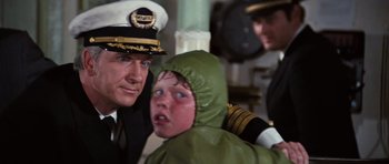 Movie still from “The Poseidon Adventure” (1972), directed by Ronald Neame – A man and a child in a uniform; Close Up shot, Over the shoulder angle