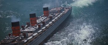 Movie still from “The Poseidon Adventure” (1972), directed by Ronald Neame – An aerial view of a large boat in the ocean; Extreme Wide shot, Overhead angle