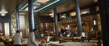 Movie still from “The Poseidon Adventure” (1972), directed by Ronald Neame – People are sitting at a restaurant with a christmas tree; Extreme Wide shot, High angle