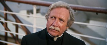 Movie still from “The Poseidon Adventure” (1972), directed by Ronald Neame – An older man wearing a priest's collar; Close Up shot, Low angle