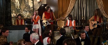 Movie still from “The Poseidon Adventure” (1972), directed by Ronald Neame – A group of young people playing instruments in a room; Wide shot, Low angle