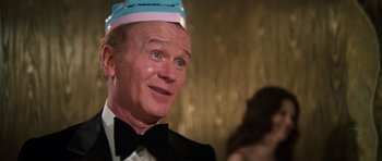 Movie still from “The Poseidon Adventure” (1972), directed by Ronald Neame – A person wearing a hat and a tuxedo; Close Up shot, Over the shoulder angle