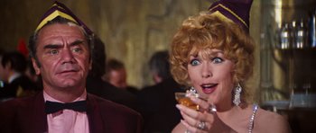 Movie still from “The Poseidon Adventure” (1972), directed by Ronald Neame – A person holding a glass of wine; Close Up shot, Over the shoulder angle