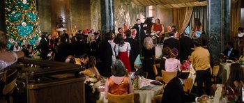 Movie still from “The Poseidon Adventure” (1972), directed by Ronald Neame – A group of people sitting at tables in a room; Extreme Wide shot, High angle