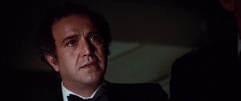 Movie still from “The Poseidon Adventure” (1972), directed by Ronald Neame – A person wearing a suit and tie; Close Up shot, Low angle