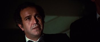 Movie still from “The Poseidon Adventure” (1972), directed by Ronald Neame – A person wearing a suit and tie; Close Up shot, Low angle