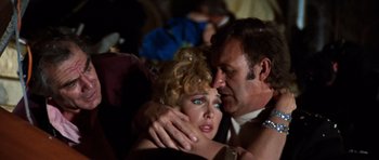 Movie still from “The Poseidon Adventure” (1972), directed by Ronald Neame – A man and a woman embracing each other in front of a crowd; Close Up shot, Low angle