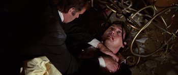 Movie still from “The Poseidon Adventure” (1972), directed by Ronald Neame – A man in a suit and tie fixing another man in a suit and tie; Close Up shot, Overhead angle