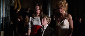 Movie still from “The Poseidon Adventure” (1972), directed by Ronald Neame – A boy and a woman standing next to each other in a crowd; Medium shot, Low angle