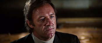 Movie still from “The Poseidon Adventure” (1972), directed by Ronald Neame – A person wearing a suit and tie; Close Up shot, Low angle