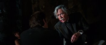 Movie still from “The Poseidon Adventure” (1972), directed by Ronald Neame – An old man with a beard and a mustache is talking to another man; Close Up shot, Over the shoulder angle