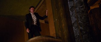 Movie still from “The Poseidon Adventure” (1972), directed by Ronald Neame – A man standing in a room with his arms outstreched; Wide shot, Low angle
