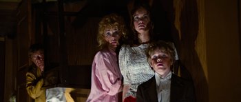 Movie still from “The Poseidon Adventure” (1972), directed by Ronald Neame – A group of people dressed up in costumes; Medium shot, Low angle