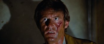 Movie still from “The Poseidon Adventure” (1972), directed by Ronald Neame – A person with blood on his face; Close Up shot, Low angle