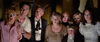 Movie still from “The Poseidon Adventure” (1972), directed by Ronald Neame – A group of people standing next to each other in a room; Medium shot, Low angle