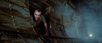 Movie still from “The Poseidon Adventure” (1972), directed by Ronald Neame – A man is looking out of an old submarine; Medium shot, Overhead angle