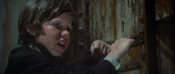 Movie still from “The Poseidon Adventure” (1972), directed by Ronald Neame – A young boy wearing a suit and white shirt; Close Up shot, Low angle