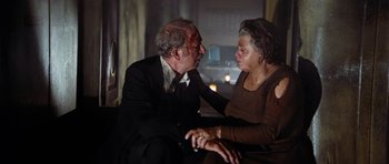 Movie still from “The Poseidon Adventure” (1972), directed by Ronald Neame – An older man and woman sitting next to each other; Medium shot, Low angle