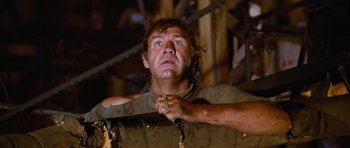 Movie still from “The Poseidon Adventure” (1972), directed by Ronald Neame – A person holding a stick; Medium shot, Low angle