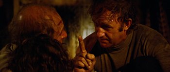 Movie still from “The Poseidon Adventure” (1972), directed by Ronald Neame – A man holding a finger up to a woman's face; Close Up shot, Over the shoulder angle