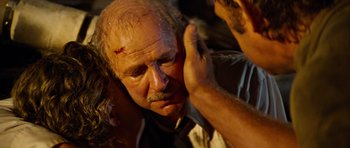 Movie still from “The Poseidon Adventure” (1972), directed by Ronald Neame – An old man with a bandaged head and hands on his face; Close Up shot, Over the shoulder angle