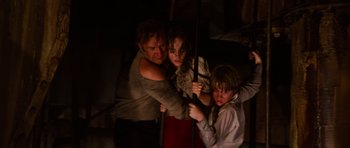 Movie still from “The Poseidon Adventure” (1972), directed by Ronald Neame – A man and two young boys holding onto a pole; Medium shot, High angle
