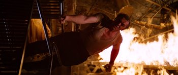 Movie still from “The Poseidon Adventure” (1972), directed by Ronald Neame – A man in a tank top is doing a handstand; Medium shot, Low angle