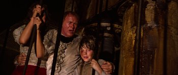 Movie still from “The Poseidon Adventure” (1972), directed by Ronald Neame – A man and a boy are standing next to each other; Medium shot, Low angle