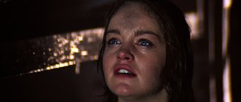 Movie still from “The Poseidon Adventure” (1972), directed by Ronald Neame – A person with wet hair crying; Close Up shot, Low angle