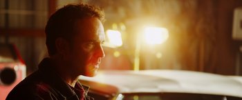 Movie still from “The Prince” (2014), directed by Brian A. Miller – A person in a car at night; Close Up shot, Over the shoulder angle
