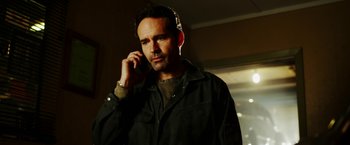 Movie still from “The Prince” (2014), directed by Brian A. Miller – A man is talking on a cell phone; Close Up shot, Low angle