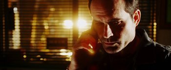 Movie still from “The Prince” (2014), directed by Brian A. Miller – A person talking on a cell phone; Close Up shot, Low angle